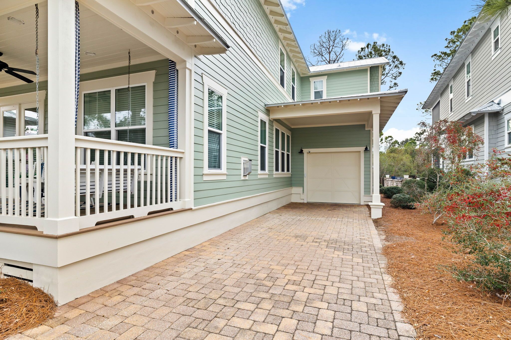 A two-story house with a covered porch and a garage.