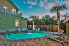 A backyard with a swimming pool, lounge chairs, and a wooden deck. - ☀️ Summer Sun | Steps from the Beach, Private Pool & Ocean Views 🌊 (Destin)