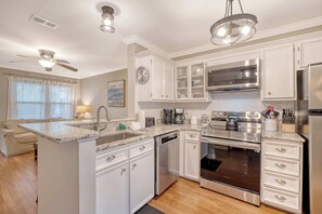 A modern kitchen with white cabinetry, a built-in oven, and a stainless steel range hood. - 2bed/1.5bath duplex; central Mount Pleasant, Near Beaches + Downtown! (Mount Pleasant)