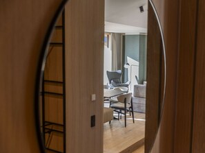 A view through a door into a room with a dining table, chairs, and a sofa. - Premium Penthouse With 3 Bedrooms (Oberndorf in Tirol)