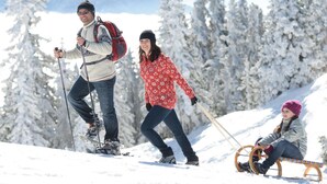 Paisaje nevado con gente disfrutando de actividades invernales.