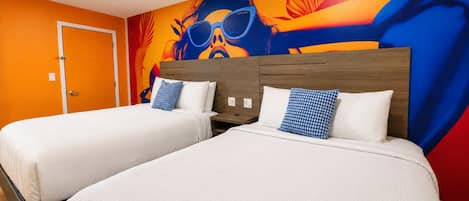 A hotel room with two beds, a colorful mural on the wall, and a door to the left.