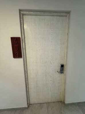 A closed door with a number plate '403' on the wall beside it. - King 1BR · 1.5 Baths · Rooftop Pool · 5th Ave (Playa del Carmen)