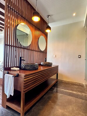 A modern bathroom with a wooden vanity, two mirrors, and pendant lighting. - Relaxing Lakeside Retreat Pool Hot Tub and Patio (Tulum)