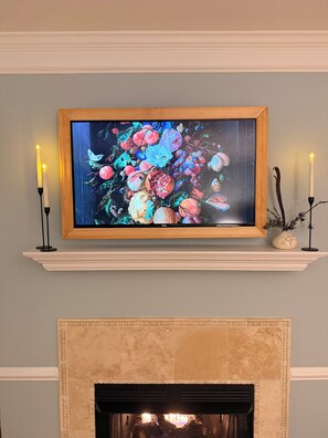 A framed artwork above a fireplace with two lit candles on either side. - Ultra Luxury Stay between Chapel Hill & Durham. (Chapel Hill)