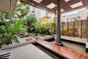 A courtyard with a seating area, plants, and a wooden pergola. - Please note: electricity is not included in reservations longer than 28... (Tulum)