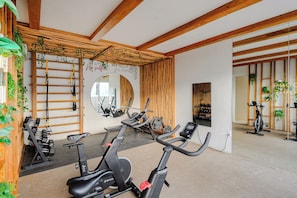 A gym with exercise equipment, wooden beams, and greenery. - Please note: electricity is not included in reservations longer than 28... (Tulum)