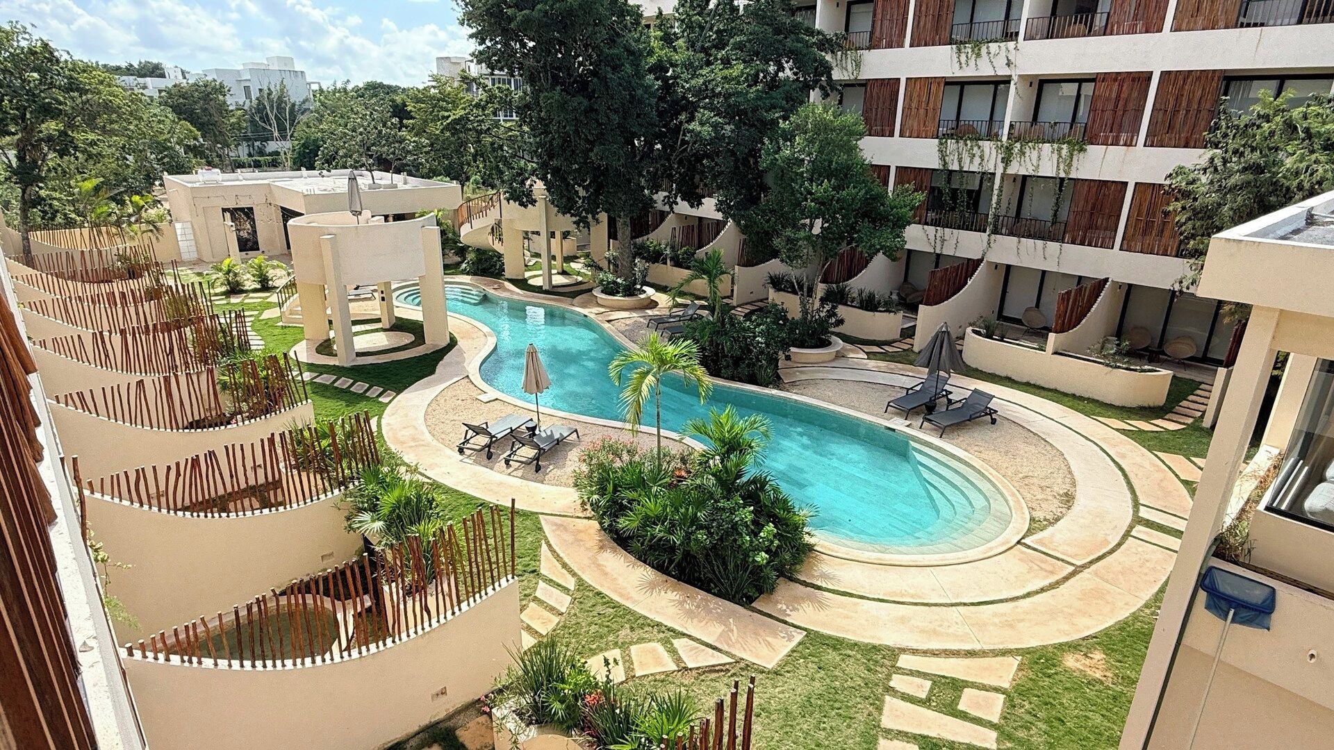 A pool area with lounge chairs and a circular pool.