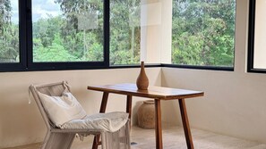 A room with a woven chair, a wooden table, and a vase. - Please note: electricity is not included in reservations longer than 28... (Tulum)