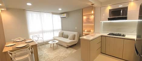A modern apartment with a kitchen, dining area, and living space.