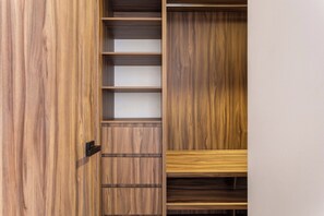 A wooden wardrobe with multiple shelves and a door. - Romantic design with pool island (Tulum)