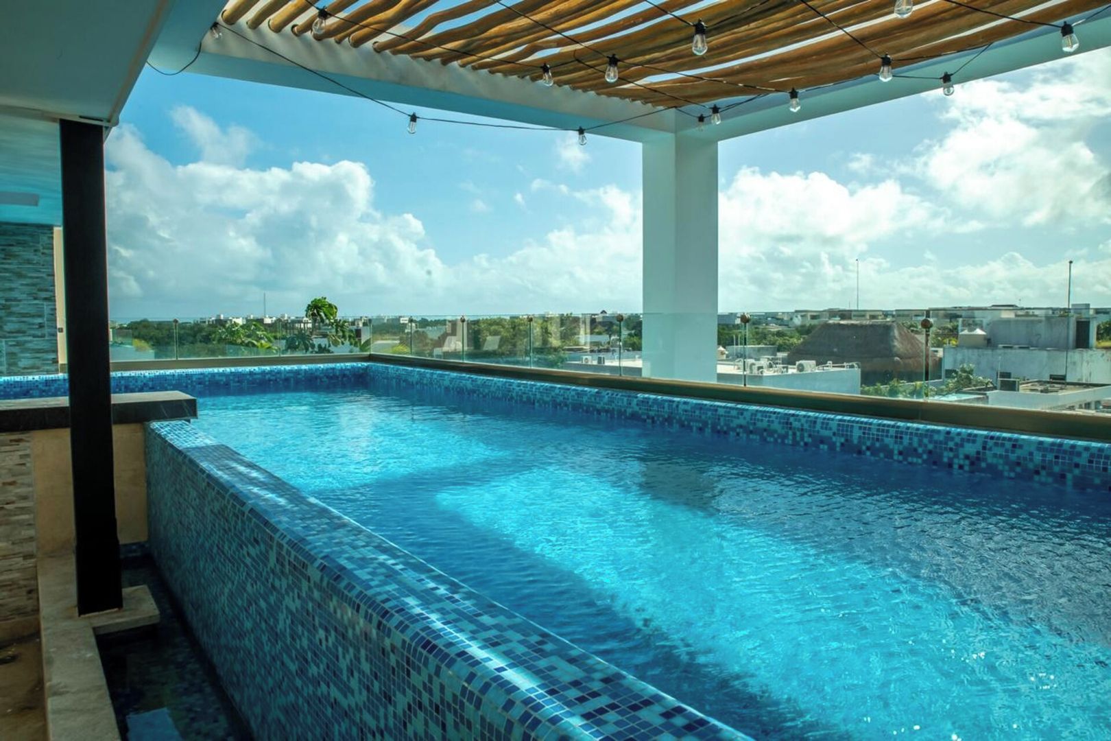 A rooftop swimming pool with a clear view of the cityscape.