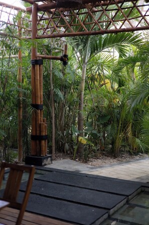 A bamboo structure with a rope and a bird perched on it, surrounded by lush greenery. - 3BR Favorite · Private Pool + Cenote · Tulum (Tulum)
