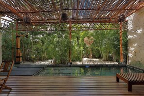 A pool area with a wooden deck, bamboo structures, and lush greenery. - 3BR Favorite · Private Pool + Cenote · Tulum (Tulum)