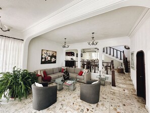 A spacious living room with a sofa set, coffee table, and a potted plant. - Hot Pool with Solar Panels! (Jiutepec)