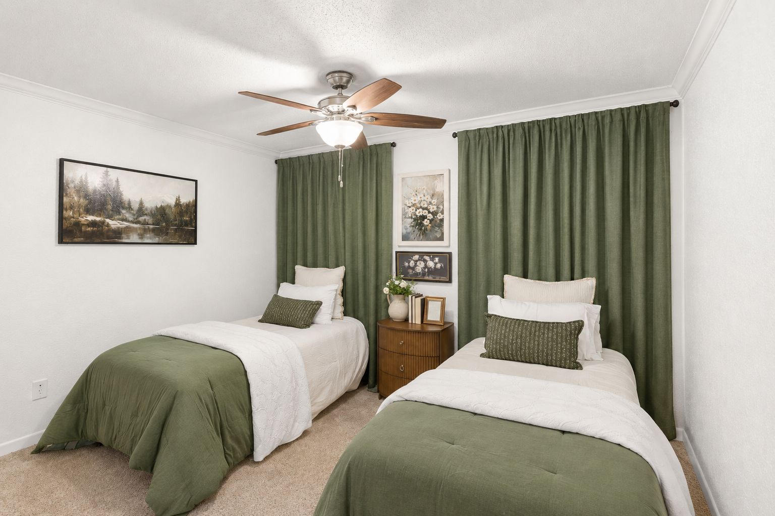 A bedroom with two beds, a ceiling fan, and green curtains.