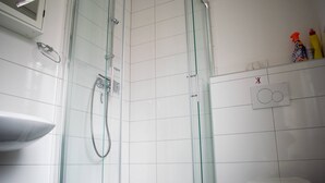 A bathroom with a glass-enclosed shower, a white sink, and a toilet. - Neuhausen Holiday Home – Ground Floor Apartment / Wi-Fi / 1 Bedroom (Neuhausen)