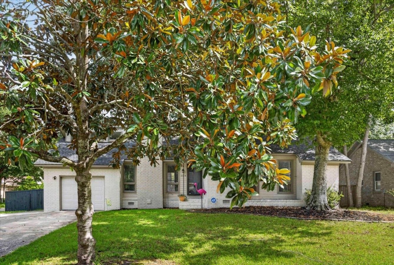 A residential house with a front yard, a driveway, and a garage.