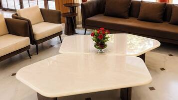 A modern lobby with a sofa, chairs, and a coffee table.