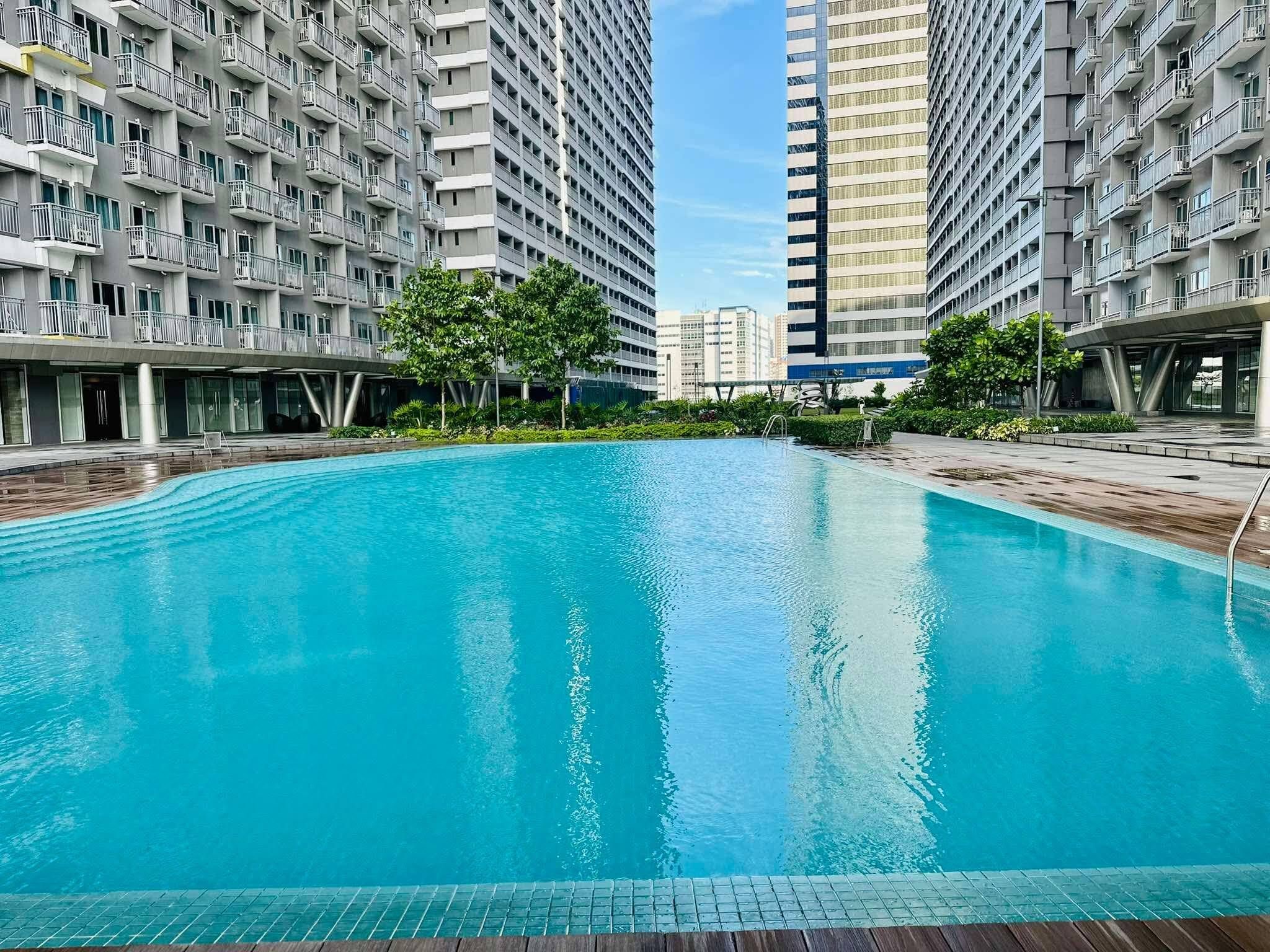 A swimming pool surrounded by high-rise residential buildings.
