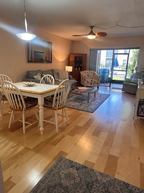 A spacious living area with a dining table, chairs, sofas, and a ceiling fan. - Tarpon Springs Poolside Retreat - Walk to Famous Sponge Docks & Spring Bayou (Tarpon Springs)