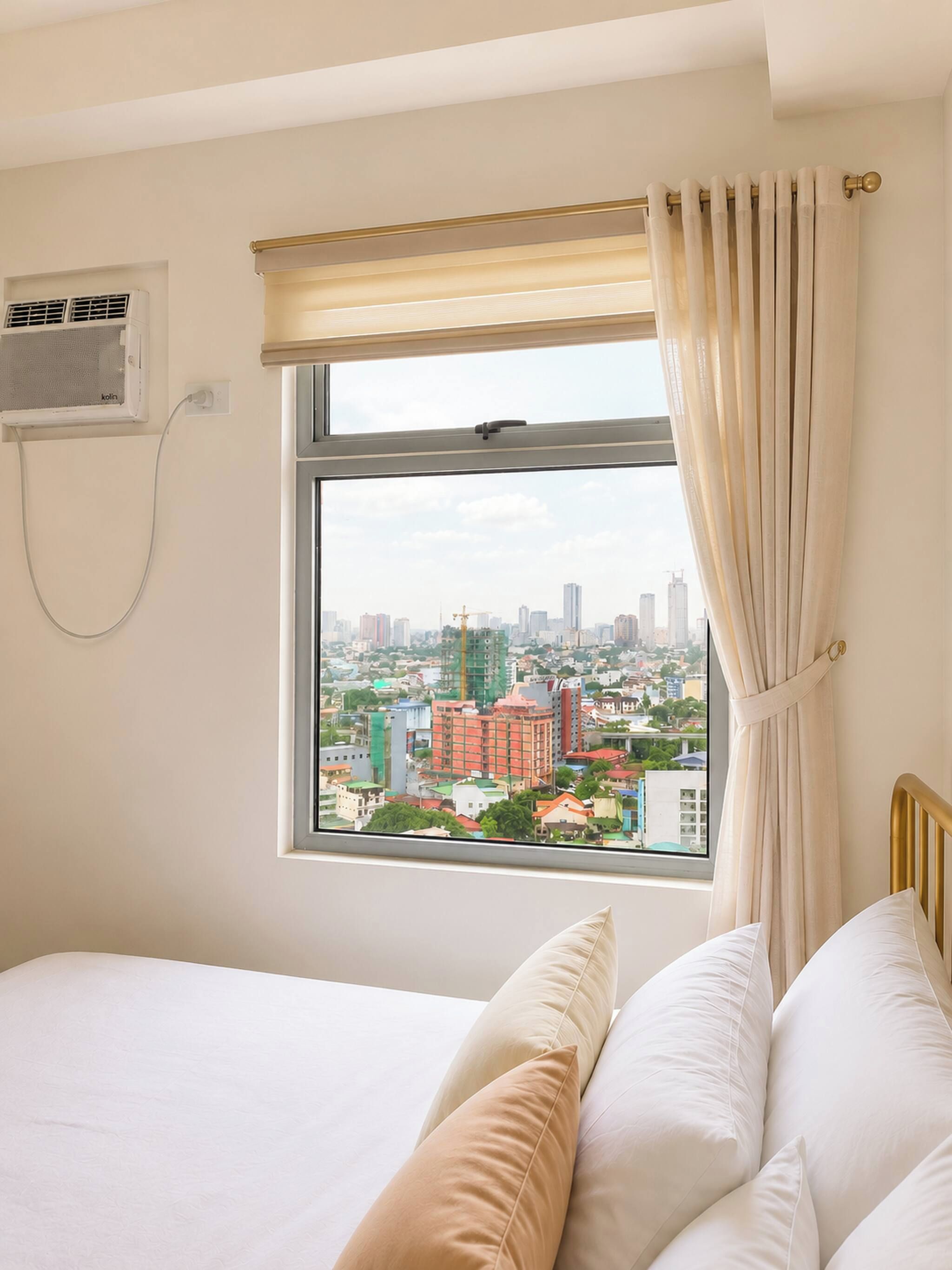 A hotel room with a bed, a window with curtains, and an air conditioning unit on the wall.