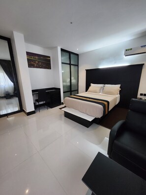A modern bedroom with a bed, a desk, and a large window. - Crib 14 (Lagos)