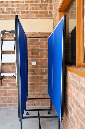 A room with a brick wall, a window, and a Bailey ladder. - McRae Hillside Terrace Panoramic Family Living (McCrae)