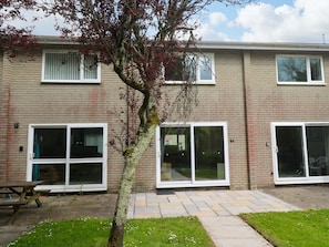 A two-story building with large windows and a tree in the foreground. - 87 Atlantic Reach (St. Columb Major)