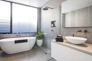 A modern bathroom with a freestanding bathtub, a vessel sink, and a shower area. - Ti Tree House Live like a Bonbeach Local (Bonbeach)