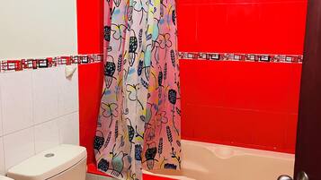 A bathroom with a toilet, sink, and bathtub.