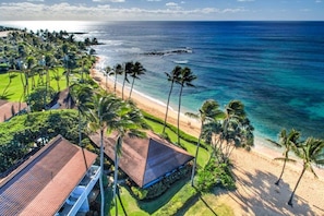 A coastal property with a beach, palm trees, and a clear view of the ocean. - Kiahuna Hale Kai II (Koloa)