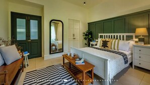 A bedroom with a bed, bedside table, nightstand, dresser, and a mirror. - French Villa with Private Pool (Awas)
