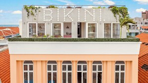 A building with a rooftop garden and the word 'BIKINI' displayed on the facade. - BIKINI (Willemstad)