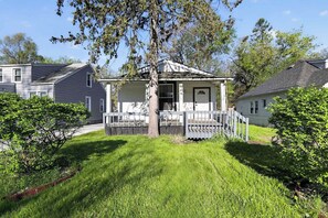 A two-story house with a porch, a small deck, and a well-maintained lawn. - Cozy Southfield Ranch (Southfield)
