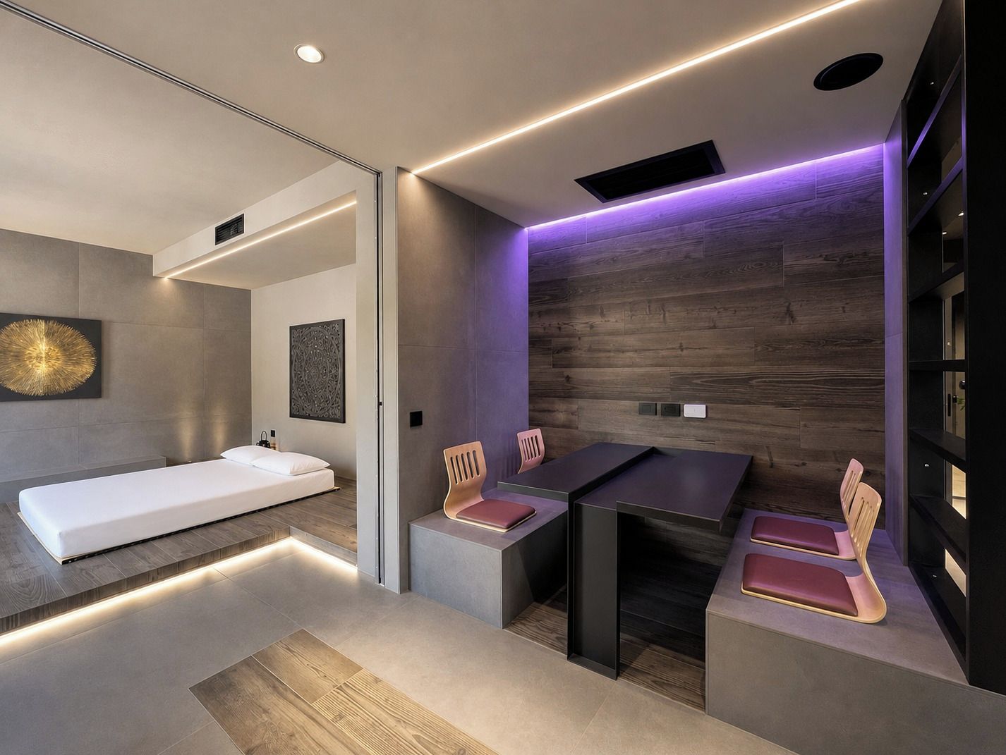 A modern hotel room with a bed, a desk, and chairs.