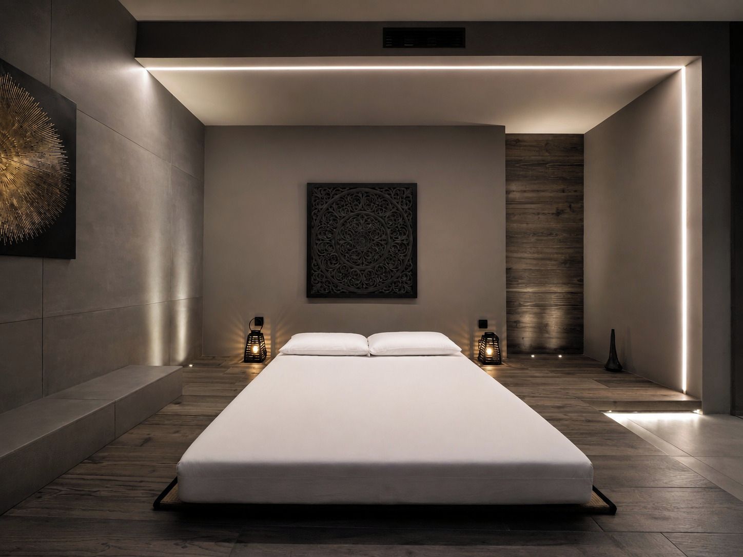 A modern bedroom with a large bed, two wall-mounted lamps, and a decorative wall piece.