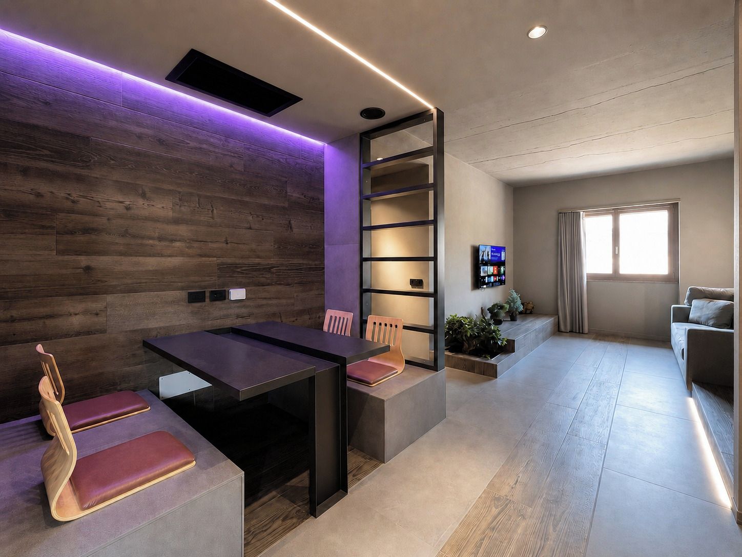 Un salon moderne avec un mur en bois foncé, un téléviseur encastré, un canapé et un coin repas comprenant une table et des chaises.