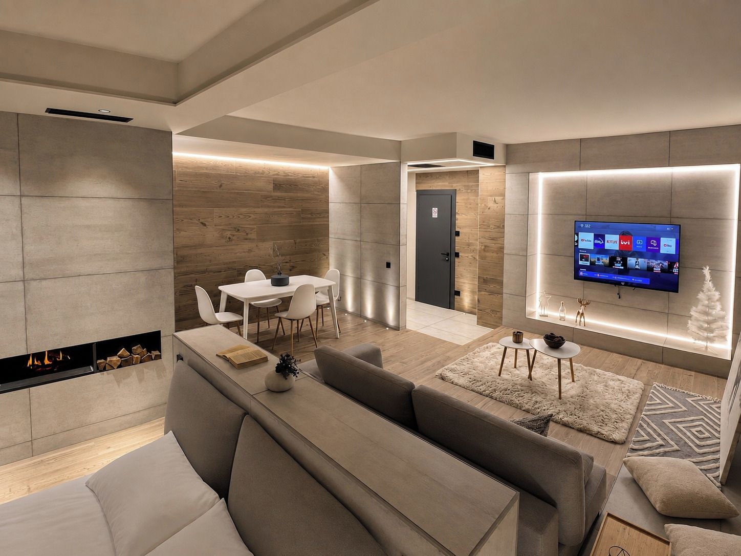 Ein modernes Wohnzimmer mit Kamin, Essbereich und einem an der Wand befestigten Flachbildfernseher.