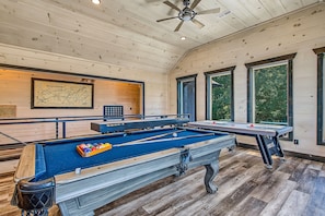 A pool table in a room with wooden walls and a ceiling fan. - Private Indoor Pool + Theater + Game Room + Fire Pit | Sleeps 12 (Sevierviille)