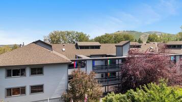 A multi-story residential building with a flat roof, multiple windows, and balconies.