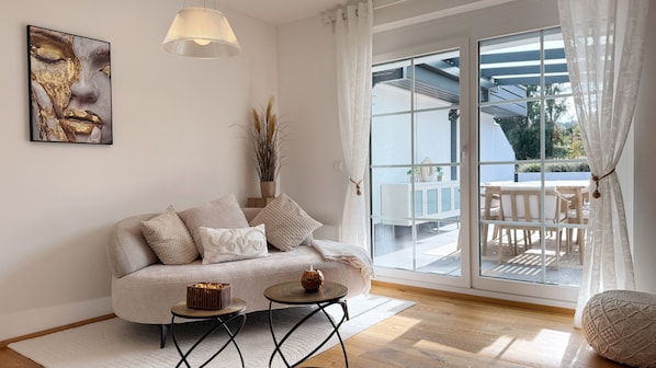 A modern living room with a sofa, a small round table, and a decorative item on the table.