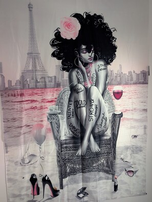 A person sitting on a chair with a cityscape and Eiffel Tower in the background.