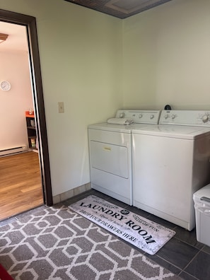 A laundry room with a washing machine, a drying machine, and a mat with text. - 2-bedroom house in welcoming Lemmon with outdoor space (Lemmon)