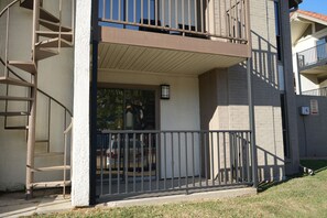 A residential building with a balcony, a staircase, and a visible door. - 5 Min to Love Field-Comfy Studio with Free Parking. (Dallas)