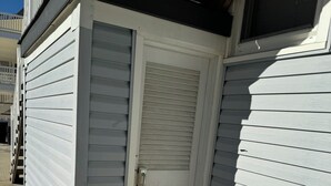 Un pequeño edificio de una sola planta, con una puerta cerrada y una ventana.