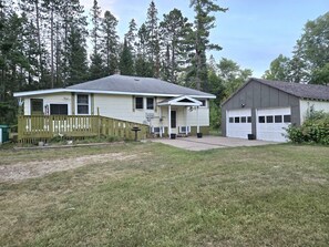 A two-story house with a front porch, a garage, and a fenced yard. - Wabana Sage House Grand Rapids, MN by the forest (Grand Rapids)