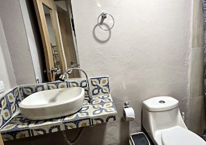 A bathroom with a sink, toilet, and a towel ring on the wall. - Hotel Agena Cabrero (Cartagena)
