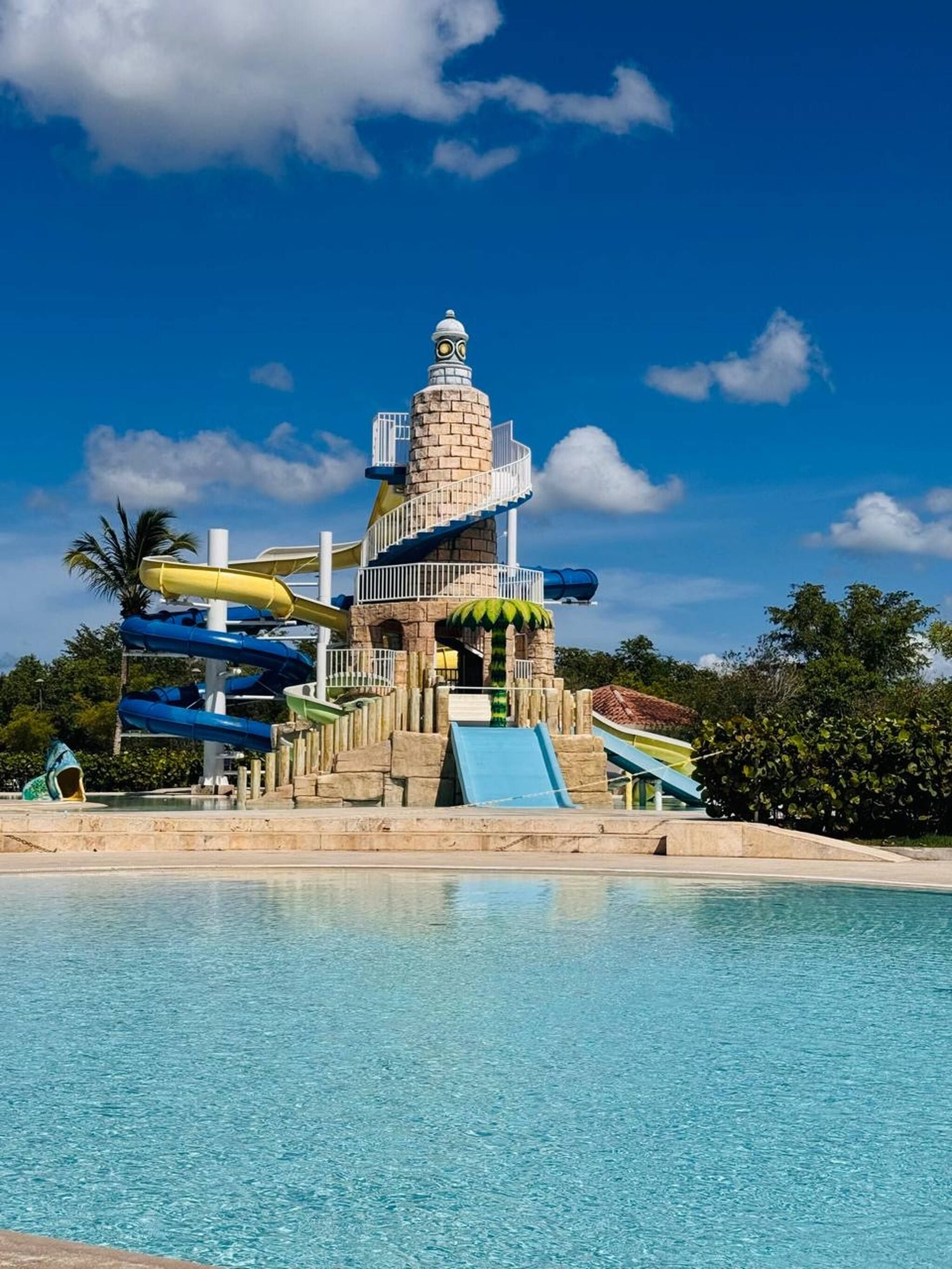 A water park with a central tower, multiple slides, and a pool.
