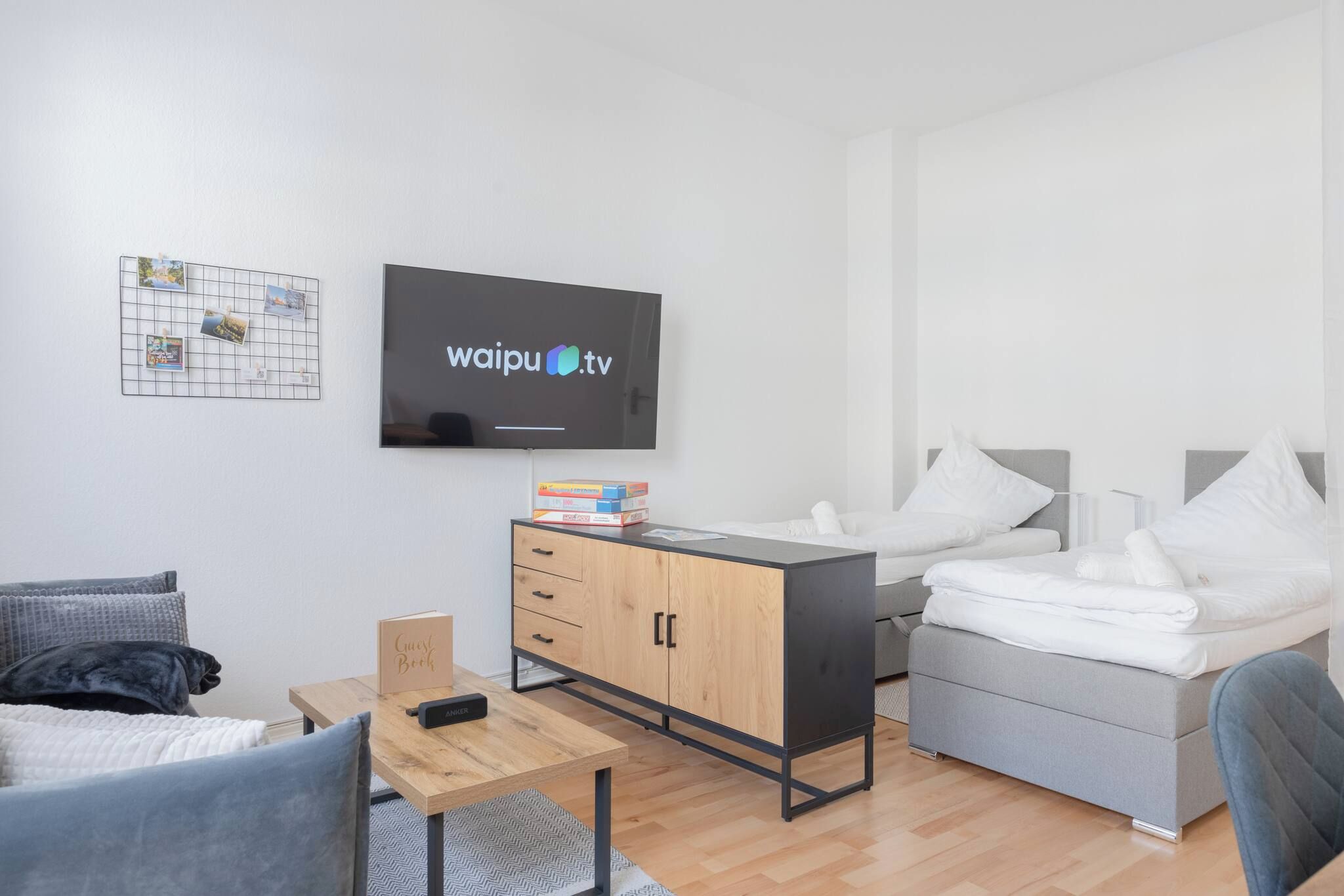 Una habitación de hotel moderna con cama, escritorio, televisor y armario.